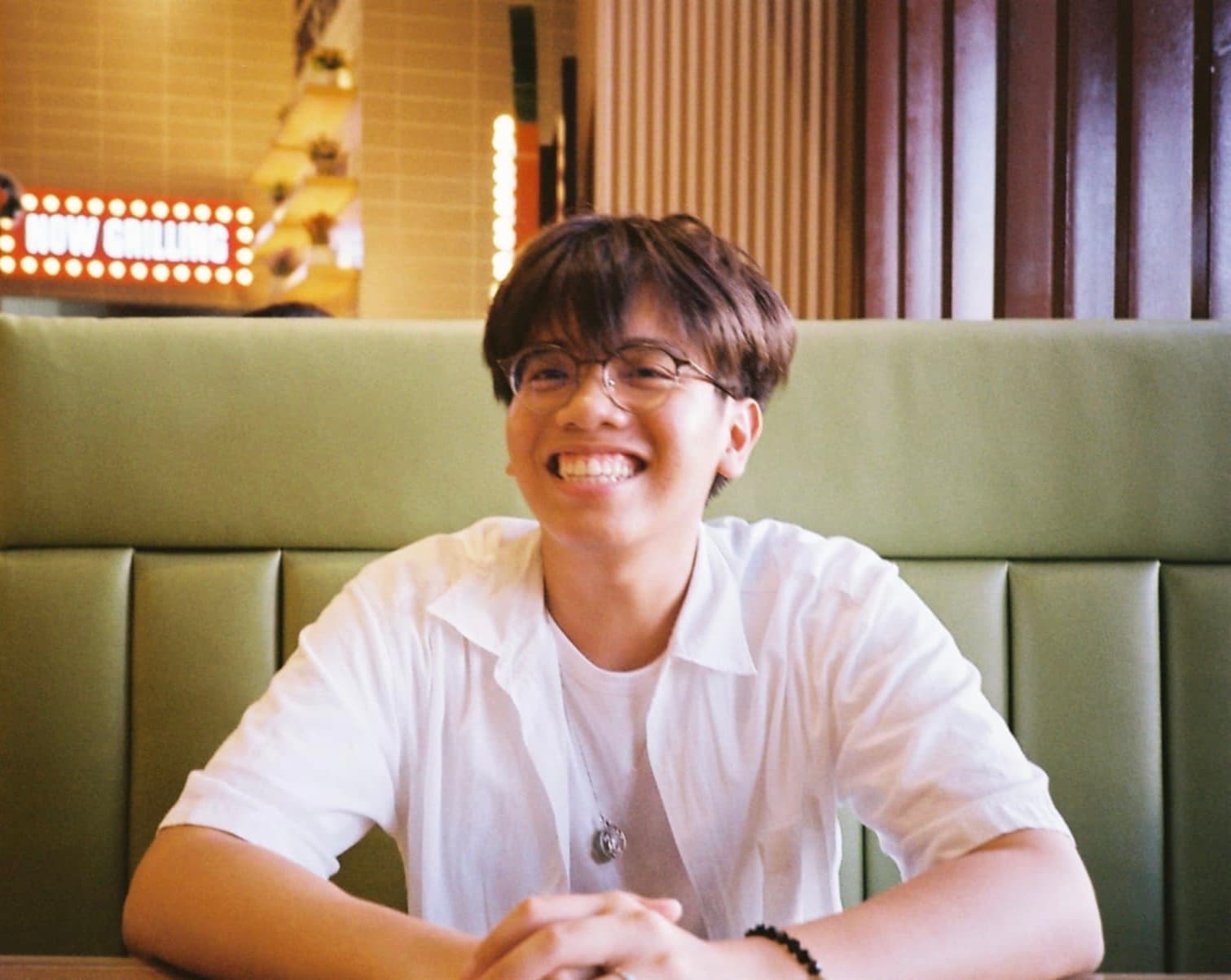 Xier Gabriel Mangunay smiling at a restaurant table
